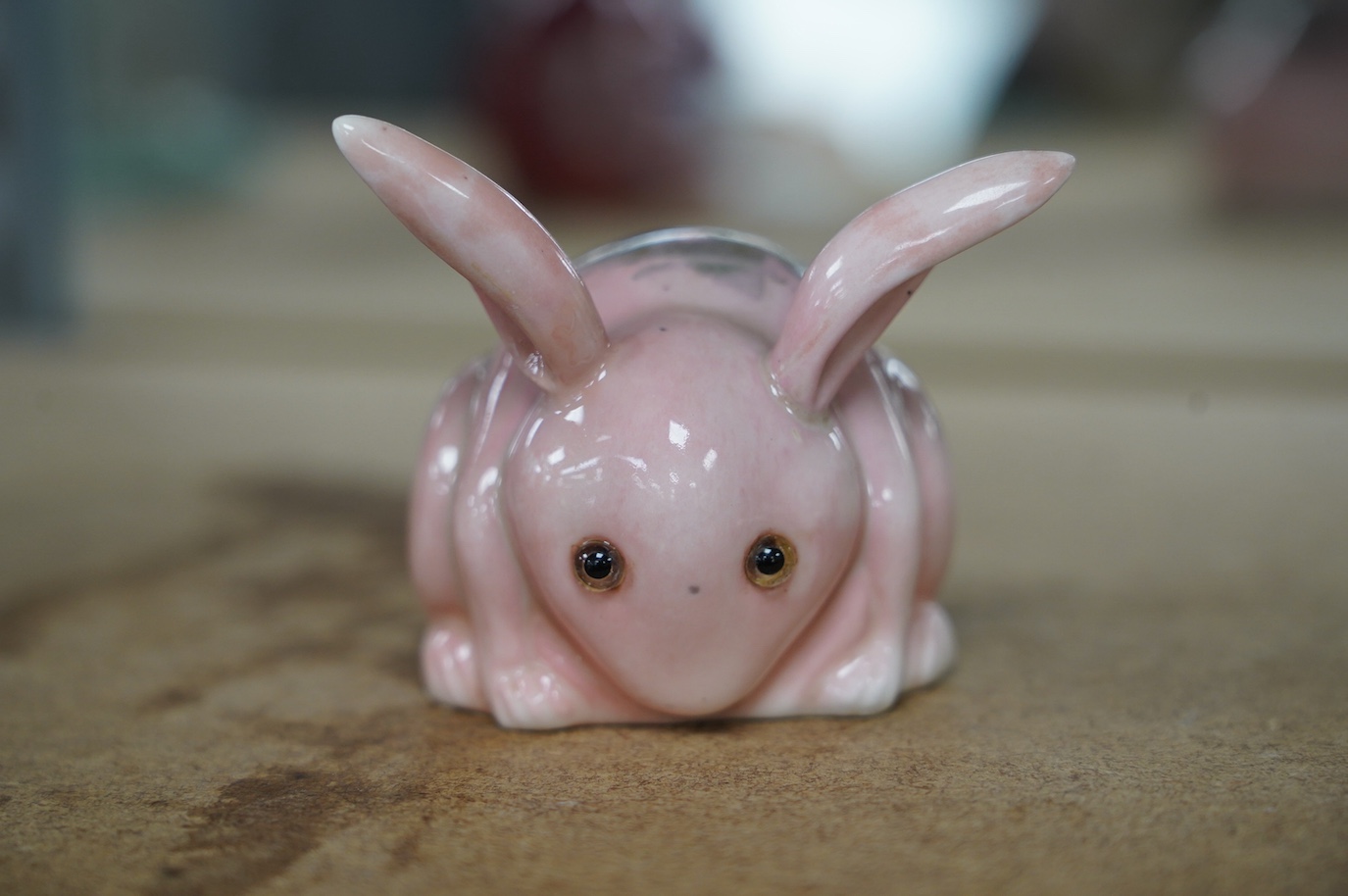 A Bernard Moore pink rabbit with glass eyes, c.1910, signed, 6.5cm. Condition - good